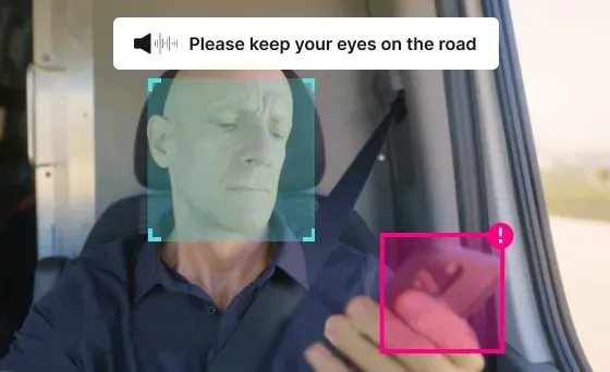 A driver looking at his phone, with a caption of "Please keep your eyes on the road"